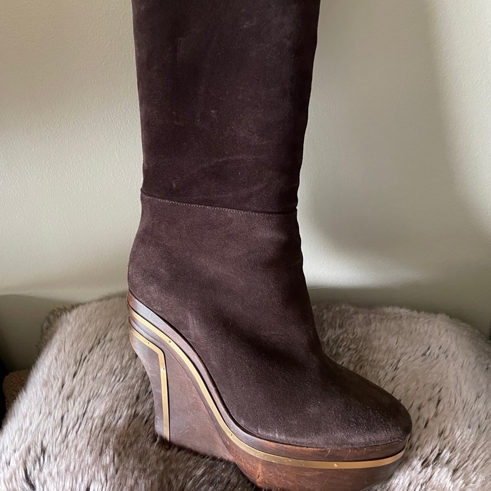 Brown suede boots with wood platform heel and gold hardware accents.